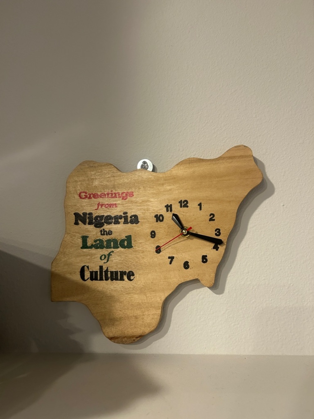 Wooden Nigeria Map Wall Clock - Natural Wood with Red, Black, Green Accents